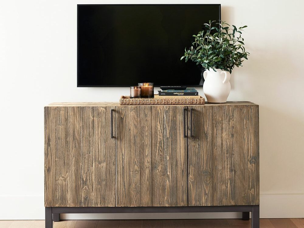 Wooden Buffet with television hanging above it