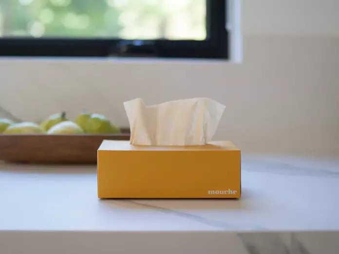 yellow mouch tissue box on a marble counter